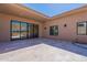 A covered patio featuring seamless sliding doors provides an inviting transition to outdoor desert landscaping at 14141 E Highland Ave, Fountain Hills, AZ 85268