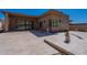 An expansive patio with stone tiling offers seamless indoor-outdoor living and desert landscaping at 14141 E Highland Ave, Fountain Hills, AZ 85268