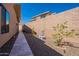 The side yard features a private walkway and rock garden accented with minimalist desert landscaping at 14141 E Highland Ave, Fountain Hills, AZ 85268