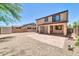 Backyard featuring a large gravel area, tile patio, and block wall at 14200 W Larkspur Dr, Surprise, AZ 85379