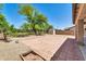 Large backyard with a tile patio and a well-maintained lawn at 14200 W Larkspur Dr, Surprise, AZ 85379