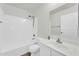 Bright bathroom with a shower-tub combo, vanity, and a large mirror at 14200 W Larkspur Dr, Surprise, AZ 85379