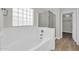 Bright bathroom features a soaking tub, glass block window, and separate glass-enclosed shower at 14200 W Larkspur Dr, Surprise, AZ 85379