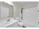 White bathroom with a shower-tub combo, vanity, and a large mirror at 14200 W Larkspur Dr, Surprise, AZ 85379
