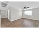 Bedroom with light wood-look floors and a ceiling fan, plus an adjoining space at 14200 W Larkspur Dr, Surprise, AZ 85379