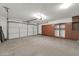 Spacious two-car garage with ample storage cabinets along the back wall at 14200 W Larkspur Dr, Surprise, AZ 85379