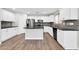 Spacious kitchen features white cabinetry, stainless steel appliances, a central island, and a tiled backsplash at 14200 W Larkspur Dr, Surprise, AZ 85379