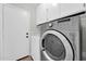 Bright laundry room features a modern washer, dryer, and storage cabinets at 14200 W Larkspur Dr, Surprise, AZ 85379