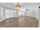 Large living room with hardwood floors, natural light, and access to the backyard via glass doors at 14200 W Larkspur Dr, Surprise, AZ 85379