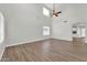 Spacious living room with tall ceilings, neutral paint, wood-look floors, and natural light at 14200 W Larkspur Dr, Surprise, AZ 85379