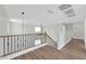 Upstairs loft area with hardwood floors, wrought iron railings, and lots of natural light at 14200 W Larkspur Dr, Surprise, AZ 85379