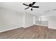 Open upstairs loft area with hardwood floors, a ceiling fan, and access to several rooms at 14200 W Larkspur Dr, Surprise, AZ 85379
