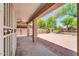 Covered patio features a ceiling fan and views of the backyard at 14200 W Larkspur Dr, Surprise, AZ 85379