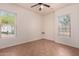 Bright bedroom with ceiling fan and large windows with mountain views at 14552 S 182Nd Dr, Goodyear, AZ 85338