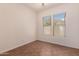 Bright bedroom with ceiling fan and large windows with desert views at 14552 S 182Nd Dr, Goodyear, AZ 85338