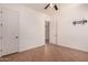 Bright bedroom with ceiling fan and door leading into the bathroom with vanity at 14552 S 182Nd Dr, Goodyear, AZ 85338