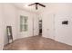 Spacious bedroom with ceiling fan, window and door leading into the bathroom with vanity at 14552 S 182Nd Dr, Goodyear, AZ 85338