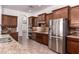 Gourmet kitchen boasts stainless appliances, granite countertops, and custom cabinetry at 14552 S 182Nd Dr, Goodyear, AZ 85338