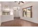 Bright living room featuring tiled floors, large windows and a view into the dining area at 14552 S 182Nd Dr, Goodyear, AZ 85338