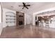 Open layout with a stone fireplace, tiled floors, and views into the kitchen and dining areas at 14552 S 182Nd Dr, Goodyear, AZ 85338