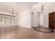 Spacious living area with tile flooring, recessed lighting, and a modern chandelier at 14552 S 182Nd Dr, Goodyear, AZ 85338