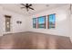 Bright and airy living room with large windows and access to the backyard pool at 14552 S 182Nd Dr, Goodyear, AZ 85338