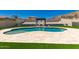 Inviting backyard pool with a relaxing cabana, surrounded by lush artificial turf and tasteful landscaping at 14552 S 182Nd Dr, Goodyear, AZ 85338