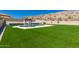 Enjoy the backyard oasis with a sparkling pool, cozy cabana, and lush green lawn, perfect for relaxation at 14552 S 182Nd Dr, Goodyear, AZ 85338
