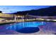 An inviting backyard pool with ambient lighting, creating a tranquil oasis for relaxation and entertaining under the night sky at 14552 S 182Nd Dr, Goodyear, AZ 85338