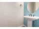 Stylish powder room featuring a pedestal sink and modern fixtures at 14552 S 182Nd Dr, Goodyear, AZ 85338