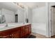 Well-lit bathroom with double sinks, vanity, and a soaking tub at 14575 W Mountain View Blvd # 11220, Surprise, AZ 85374