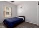 Simple bedroom with a window and wood-look flooring at 14575 W Mountain View Blvd # 11220, Surprise, AZ 85374