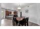 Open dining and kitchen area with modern appliances, seating at the kitchen island, and a dark wood table at 14575 W Mountain View Blvd # 11220, Surprise, AZ 85374