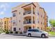 Charming, multi-level condo featuring private balconies, and desert landscaping with a silver van parked out front at 14575 W Mountain View Blvd # 11220, Surprise, AZ 85374
