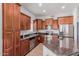 Modern kitchen with stainless steel appliances, spacious granite counters, and dark wood cabinets at 14575 W Mountain View Blvd # 11220, Surprise, AZ 85374