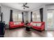 Bright living room with stylish wood floors, two couches and lots of light from the large window at 14575 W Mountain View Blvd # 11220, Surprise, AZ 85374