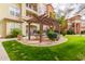 Outdoor barbecue and picnic area with a wooden pergola and seating at 14575 W Mountain View Blvd # 11220, Surprise, AZ 85374