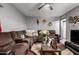 Inviting living room with a large sectional sofa, ceiling fan, and decorative accents at 14823 N 29Th Ave, Phoenix, AZ 85053