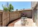 Private back patio with brick pavers, wooden fence, grill, and outdoor seating at 15407 N 2Nd St, Phoenix, AZ 85022