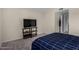 Bedroom has a television on stand, carpeted floor, and closet in doorway at 15407 N 2Nd St, Phoenix, AZ 85022