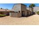 Two-story townhome featuring a private gravel front yard and neutral stucco facade at 15407 N 2Nd St, Phoenix, AZ 85022