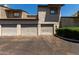 View of garages in neutral color and asphalt driveway on a sunny day at 15407 N 2Nd St, Phoenix, AZ 85022