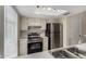 Well-lit kitchen showcasing stainless steel appliances and ample counter space with bright lighting from above at 15407 N 2Nd St, Phoenix, AZ 85022