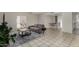 Living room with a couch, area rug, tile floors, and dining area at 15407 N 2Nd St, Phoenix, AZ 85022