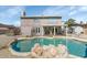 Spacious backyard featuring a pool, hot tub, patio, and a two-story house at 17819 N 46Th Dr, Glendale, AZ 85308