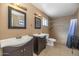 Bathroom featuring double vanity, tiled walk-in shower, and neutral colors at 17819 N 46Th Dr, Glendale, AZ 85308
