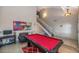 View of the billiard table, sofa, and staircase in the living room of the home at 17819 N 46Th Dr, Glendale, AZ 85308