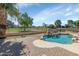 Beautiful pool with a rock waterfall feature and a picturesque view of the golf course at 17819 N 46Th Dr, Glendale, AZ 85308