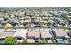Aerial view of a suburban neighborhood with homes, landscaping, and amenities such as sports field at 18072 W Paradise Ln, Surprise, AZ 85388