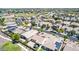 Aerial view of a neighborhood with multiple homes and properties, with a sports field in the background at 18072 W Paradise Ln, Surprise, AZ 85388
